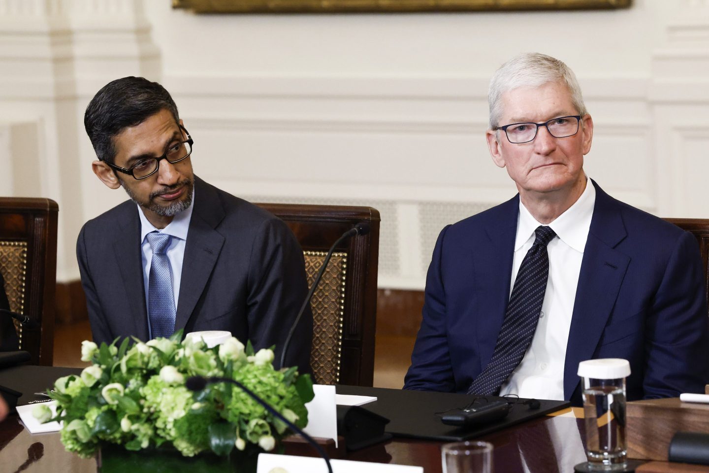 Google CEO Sundar Pichai (L) and Apple CEO Tim Cook (R) listen as U.S. President Joe Biden speaks during a roundtable with American and Indian business leaders in the East Room of the White House on June 23, 2023 in Washington, DC.