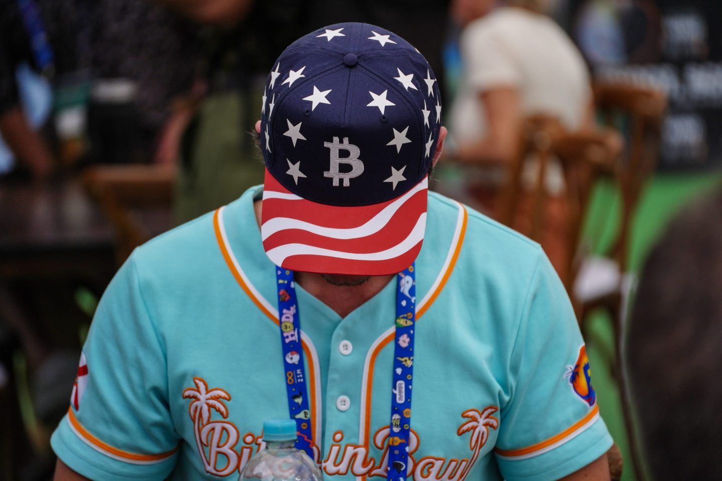 An attendee wears a Bitcoin hat on the exhibition floor during the Plan B Forum in San Salvador, El Salvador, on Jan. 31, 2025. 