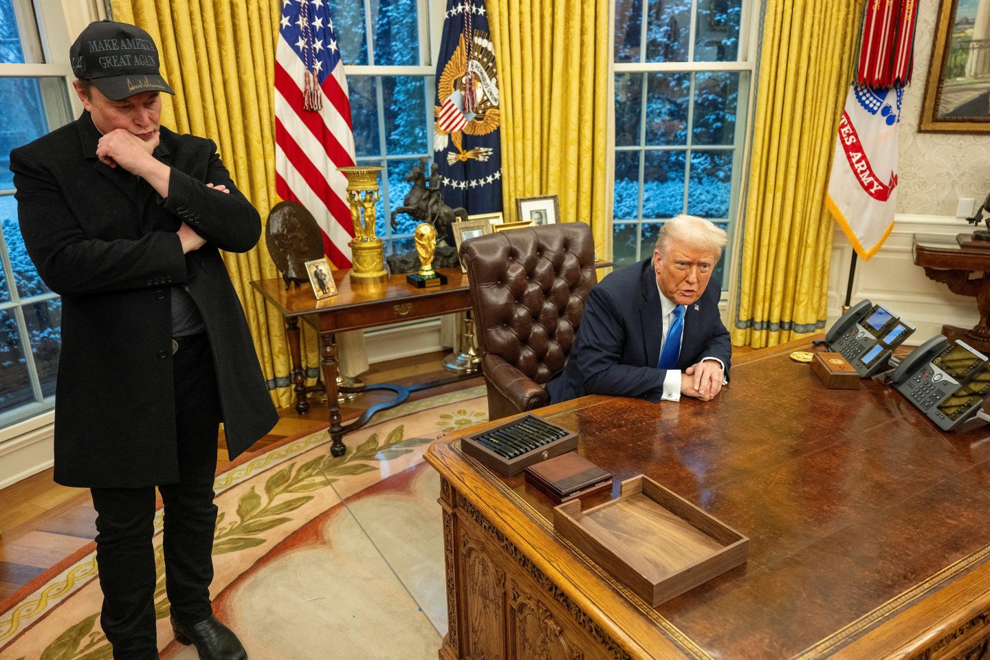 Elon Musk listens as U.S. President Donald Trump speaks in the Oval Office of the White House in Washington, D.C., on February 11, 2025. 