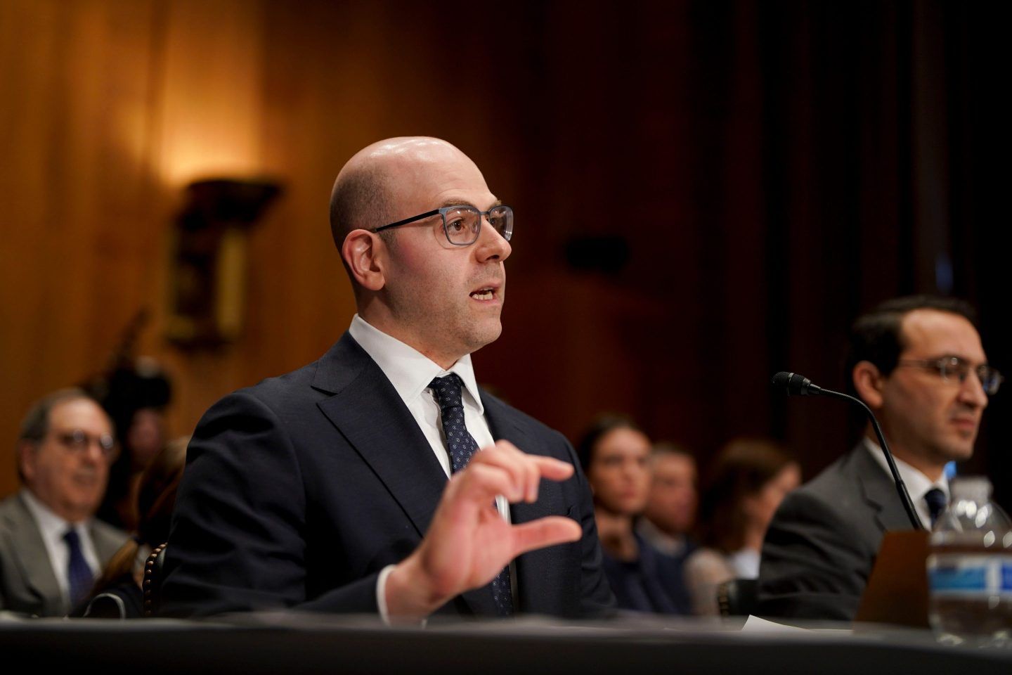 Stephen Miran makes a gap between his thumb and right index finger with his right hand as he talks at his Senate confirmation hearing.
