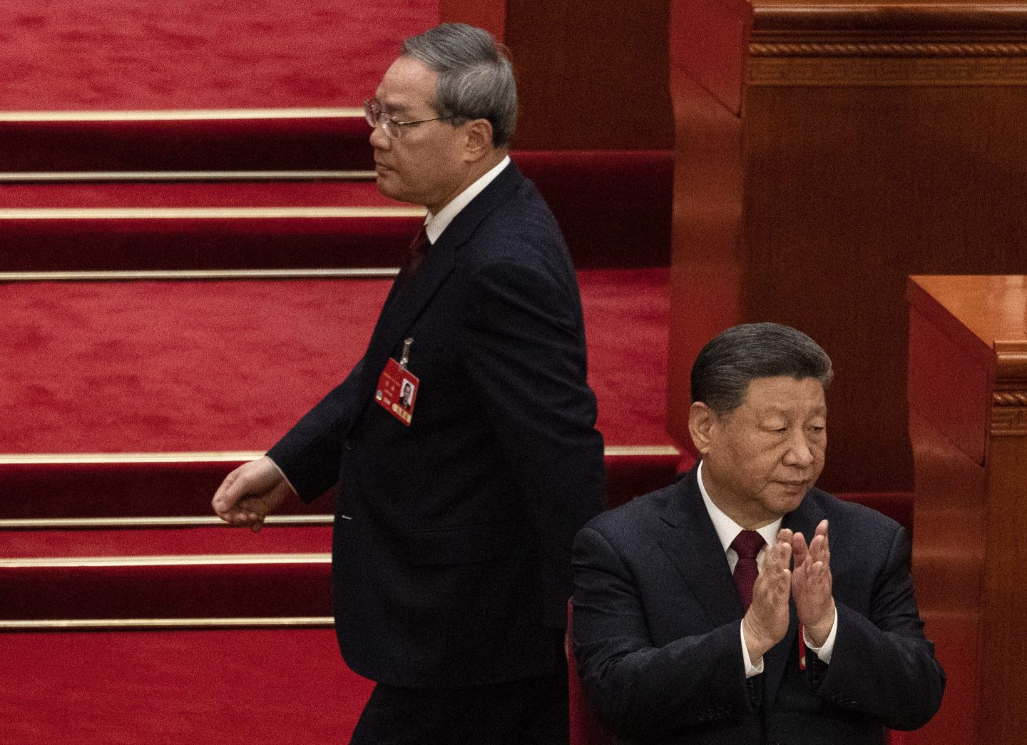 "Domestically, the foundation for China's sustained economic recovery and growth is not strong enough," said Premier Li Qiang, pictured above passing behind president Xi Jinping.