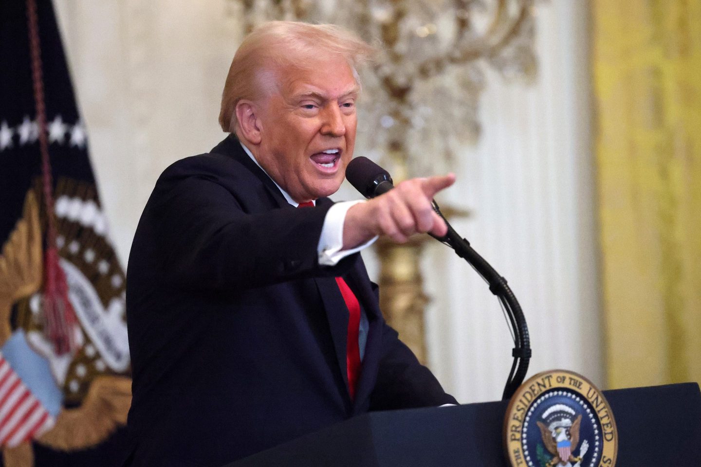 U.S. President Donald Trump gestures while speaking during a Women's History Month event in the East Room of the White House on March 26.
