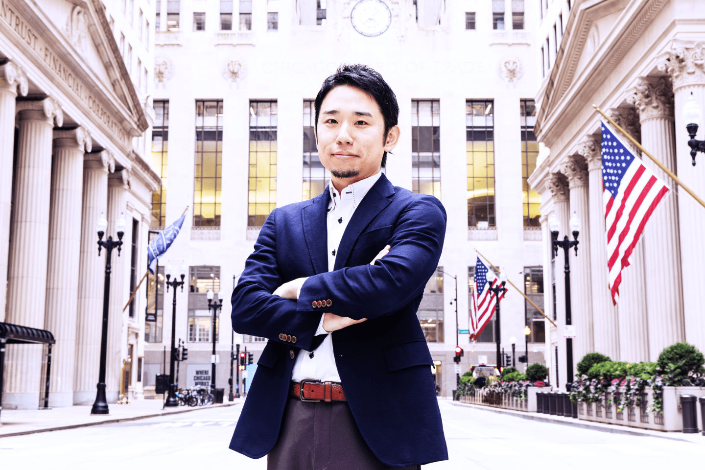 CADDi cofounder and CEO Yushiro Kato standing on a street in the U.S. with his arms crossed.