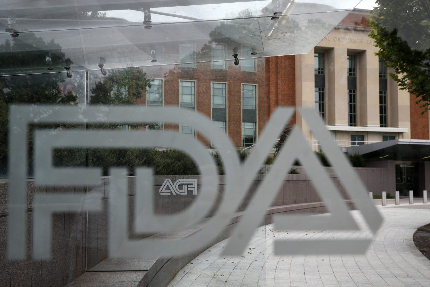 The U.S. Food and Drug Administration building behind FDA logos at a bus stop on the agency's campus in Silver Spring, Md, on Aug. 2, 2018.