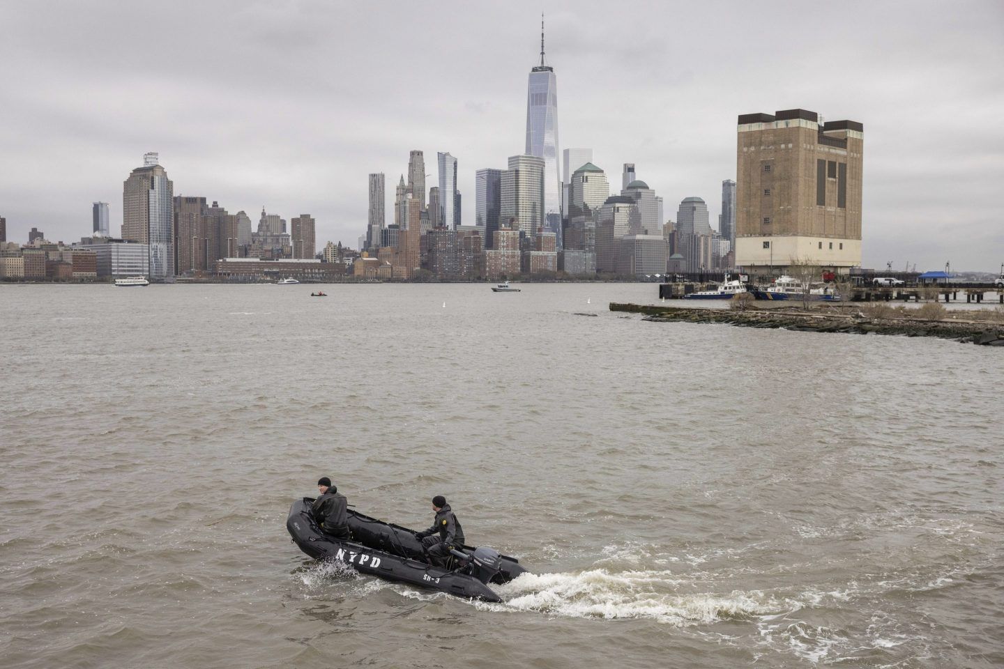 A New York Police Department scuba team looks for debris, on April 11, 2025, where a sightseeing helicopter crashed a day earlier into the Hudson River.