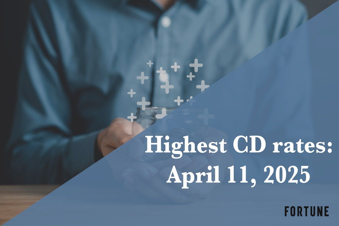 A person holding a jar full of coins.