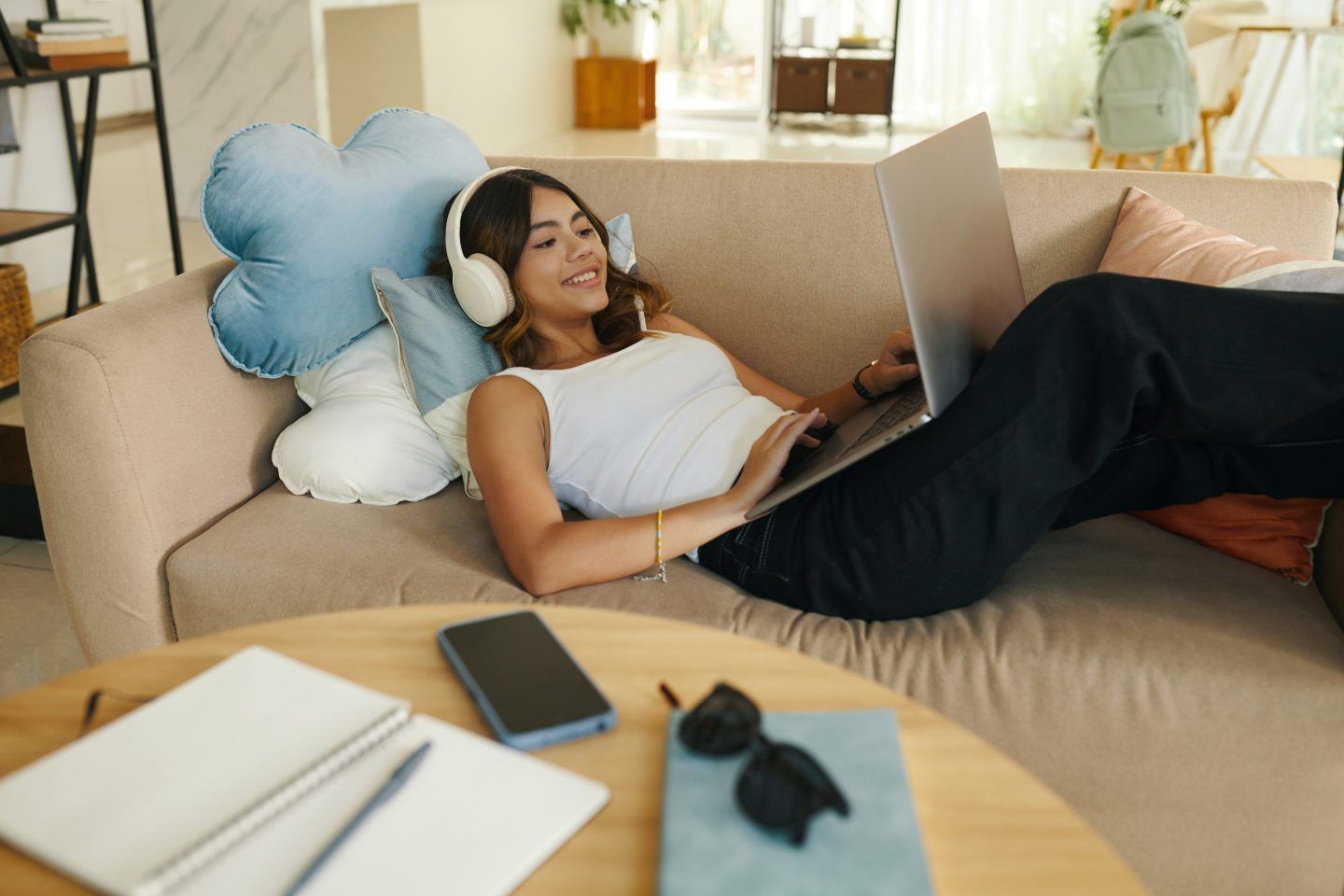 woman laying on couch working