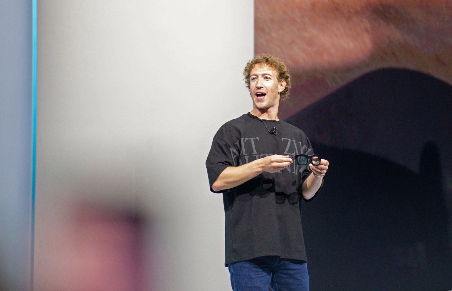 Mark Zuckerberg wearing a black t-shirt on a stage.