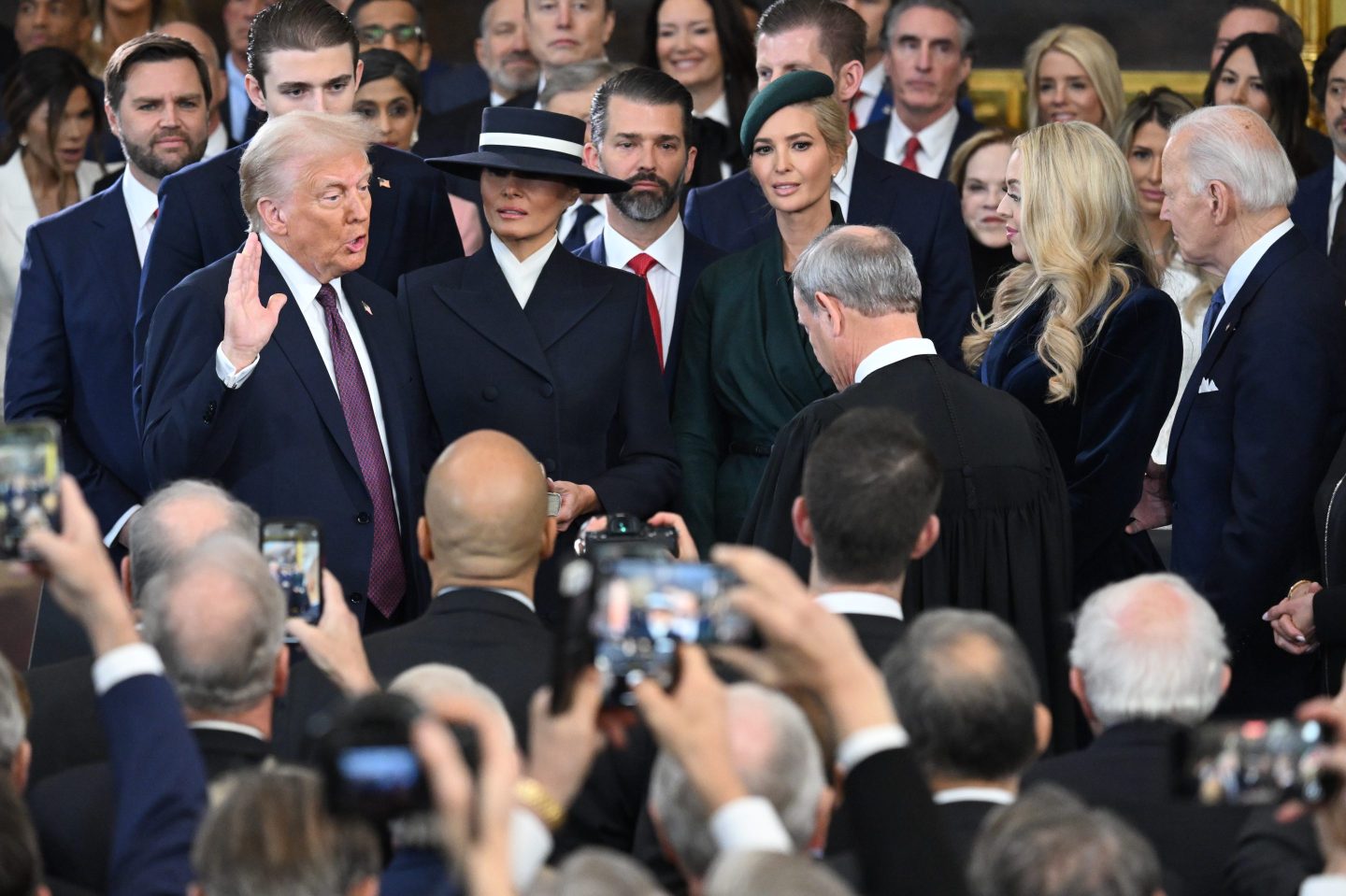 Donald Trump is sworn into office by Supreme Court Chief Justice John Roberts as Melania Trump holds the Bible  in the U.S. Capitol Rotunda on Jan. 20, 2025 in Washington, D.C.