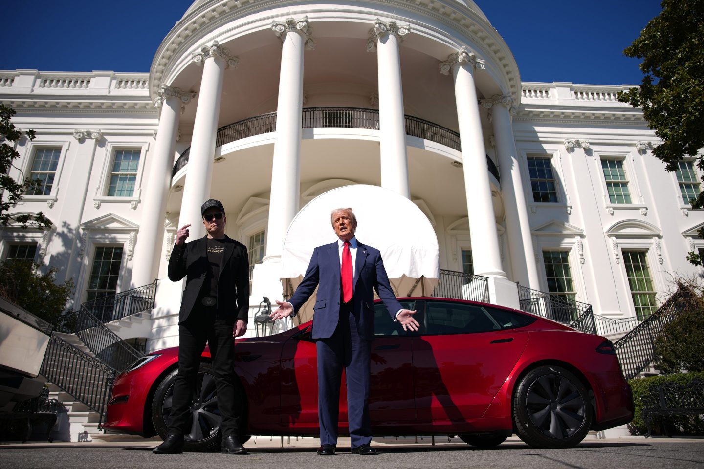 President Trump and White House Senior Advisor, Tesla CEO Elon Musk deliver remarks next to a Tesla Model S on the South Lawn of the White House on March 11, 2025 in Washington, D.C. The South Lawn became a kind of Tesla showroom, as Trump—holding a Tesla pricelist—spoke out against calls for a boycott of Musk’s companies and said he would purchase a Tesla vehicle in what he called a ‘show of confidence and support’ for Musk.  