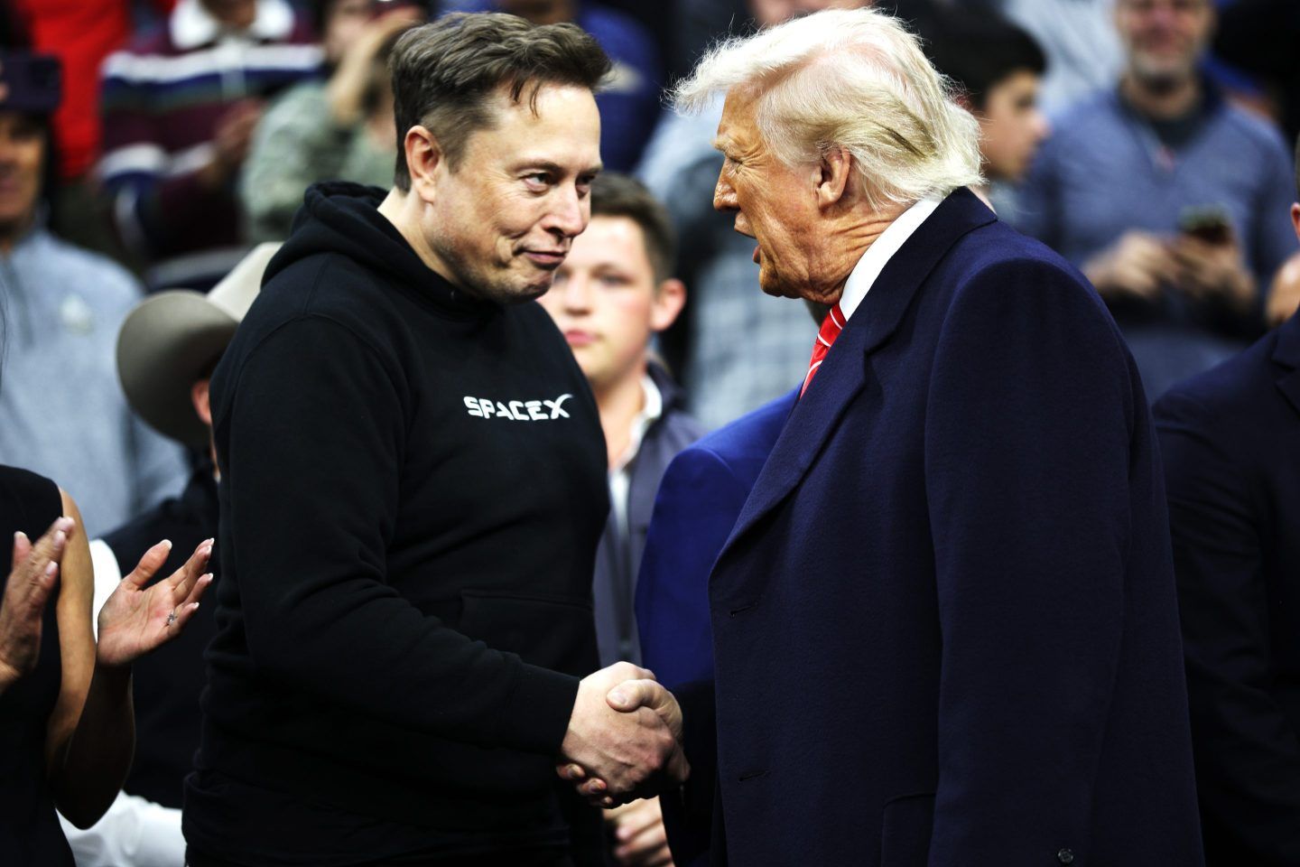 President Donald Trump and White House Senior Advisor, Tesla and SpaceX CEO Elon Musk shake hands while attending the NCAA Division I Wrestling Championship on March 22.
