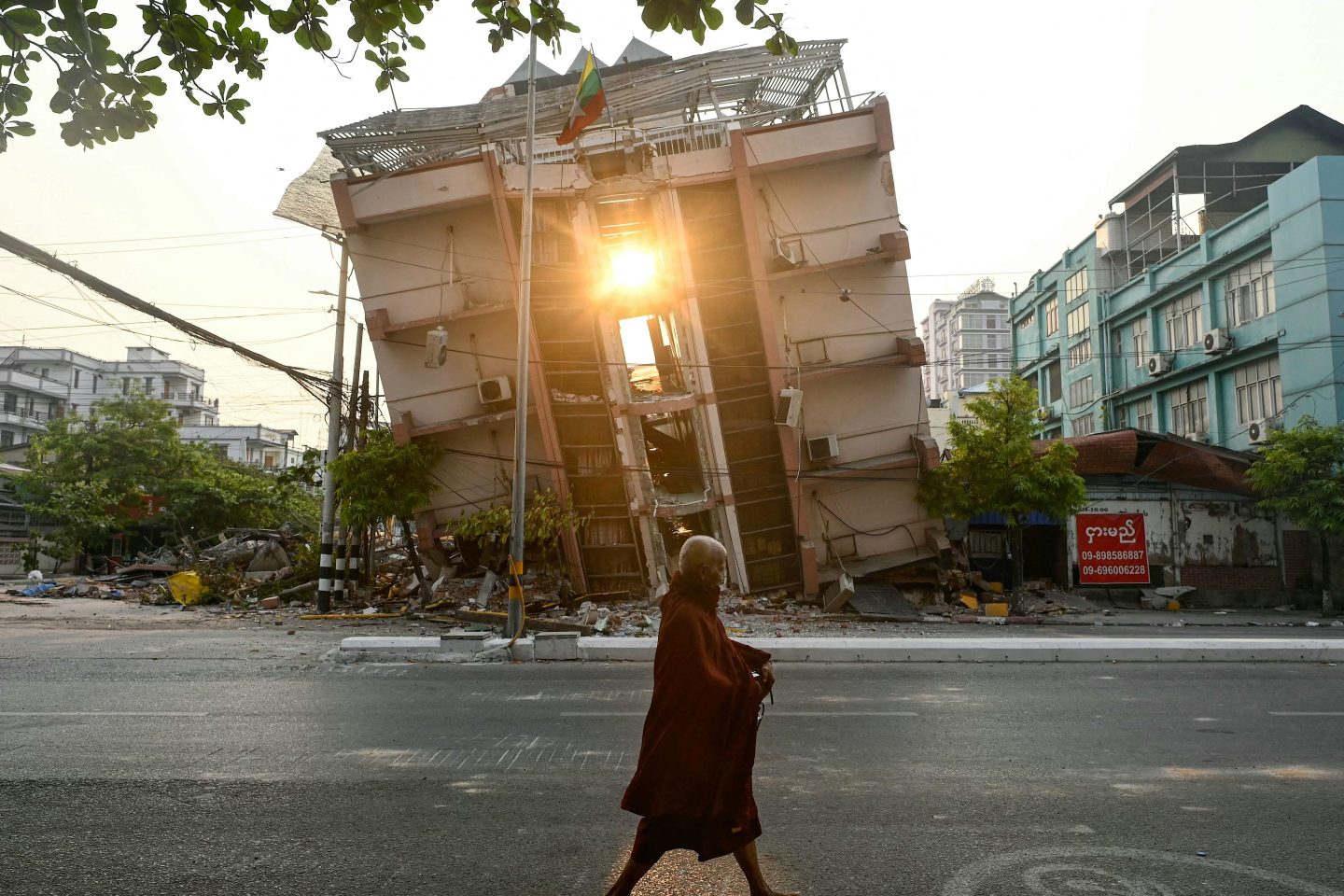 A monk walks past a collapsed building in Mandalay on April 1, 2025, a few days after the deadly Myanmar earthquake.