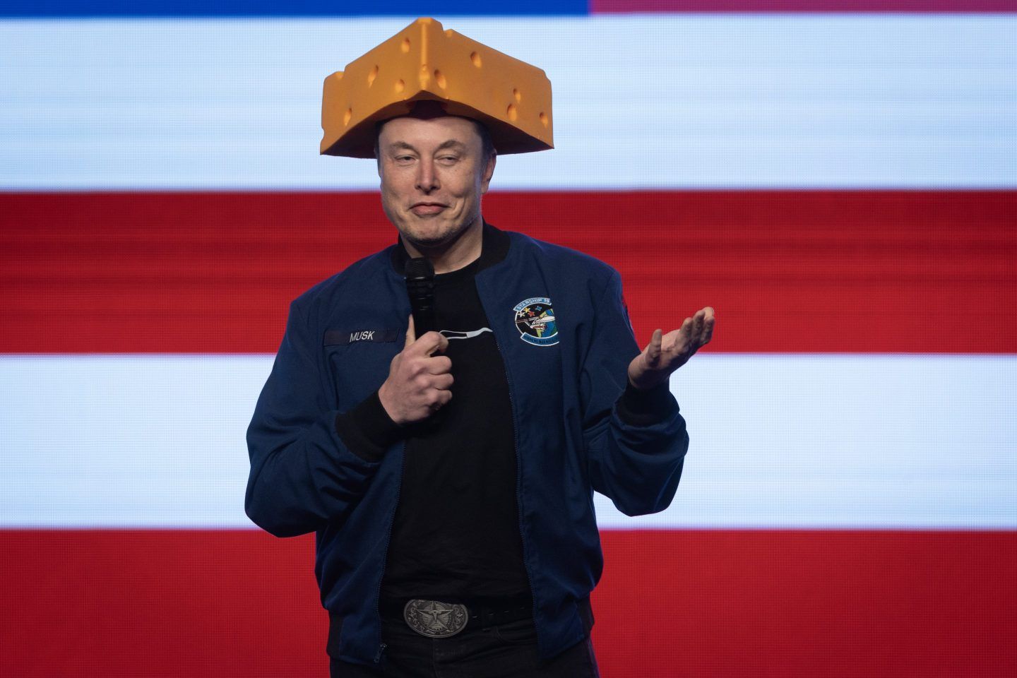 Billionaire businessman Elon Musk arrives for a town hall wearing a cheesehead hat at the KI Convention Center on March 30, 2025 in Green Bay, Wisconsin.