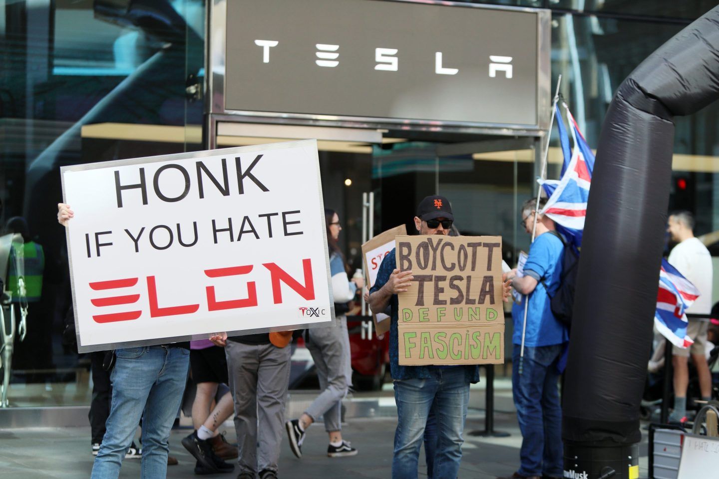 Demonstrators rally against Tesla CEO Elon Musk, US President Donald Trump and their recent policies outside a Tesla showroom on April 05, 2025 in London, England.