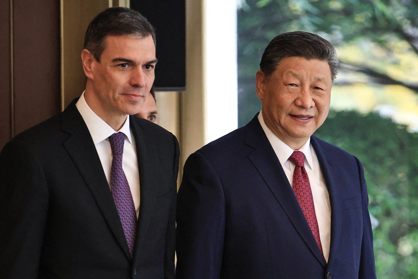 China's President Xi Jinping (R) and Spain's Prime Minister Pedro Sanchez arrive to a bilateral meeting at Diaoyutai Guest House in Beijing on April 11, 2025.