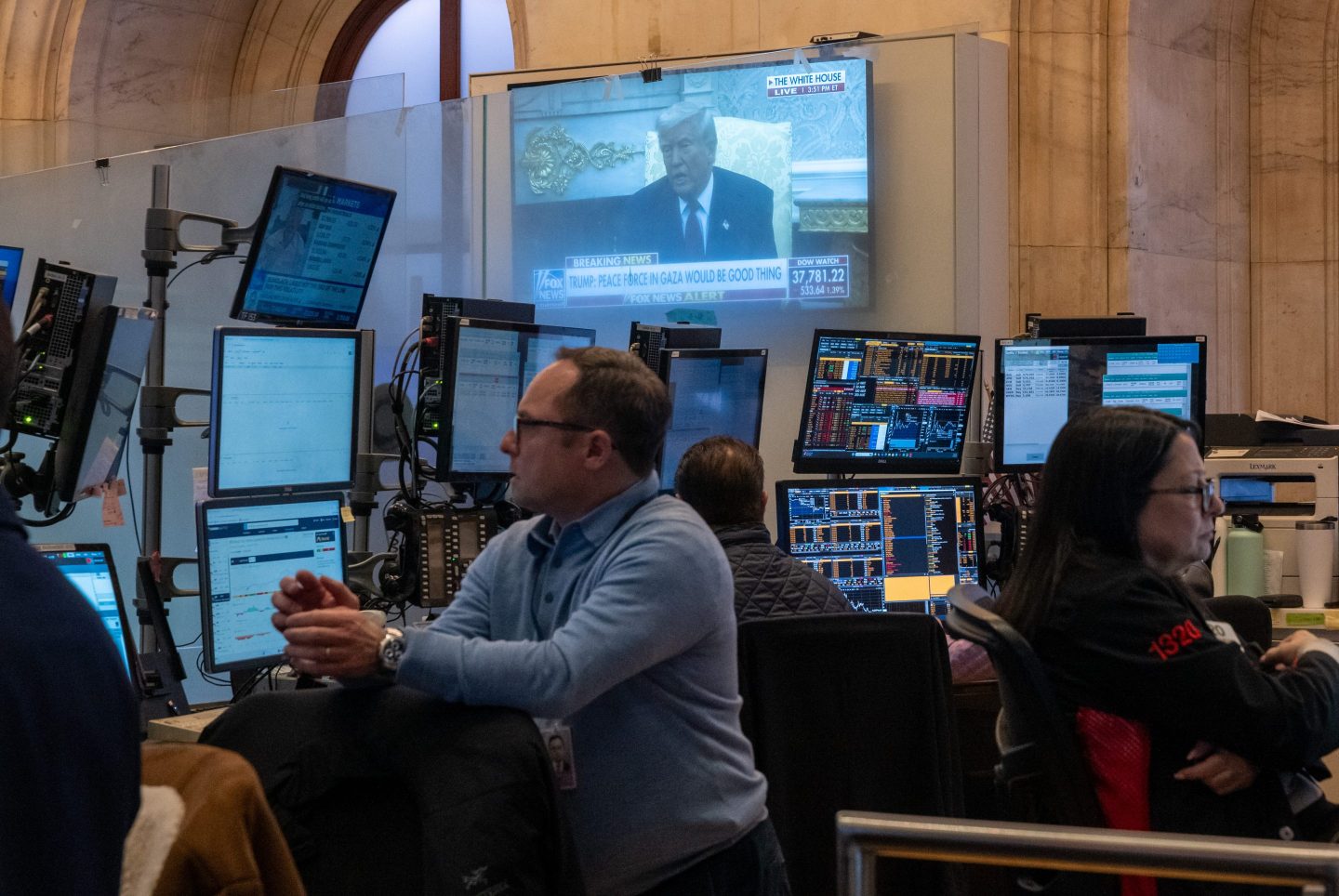 President Donald Trump is displayed on a television screen as traders work on the floor of the New York Stock Exchange on April 7th, 2025 in New York City.