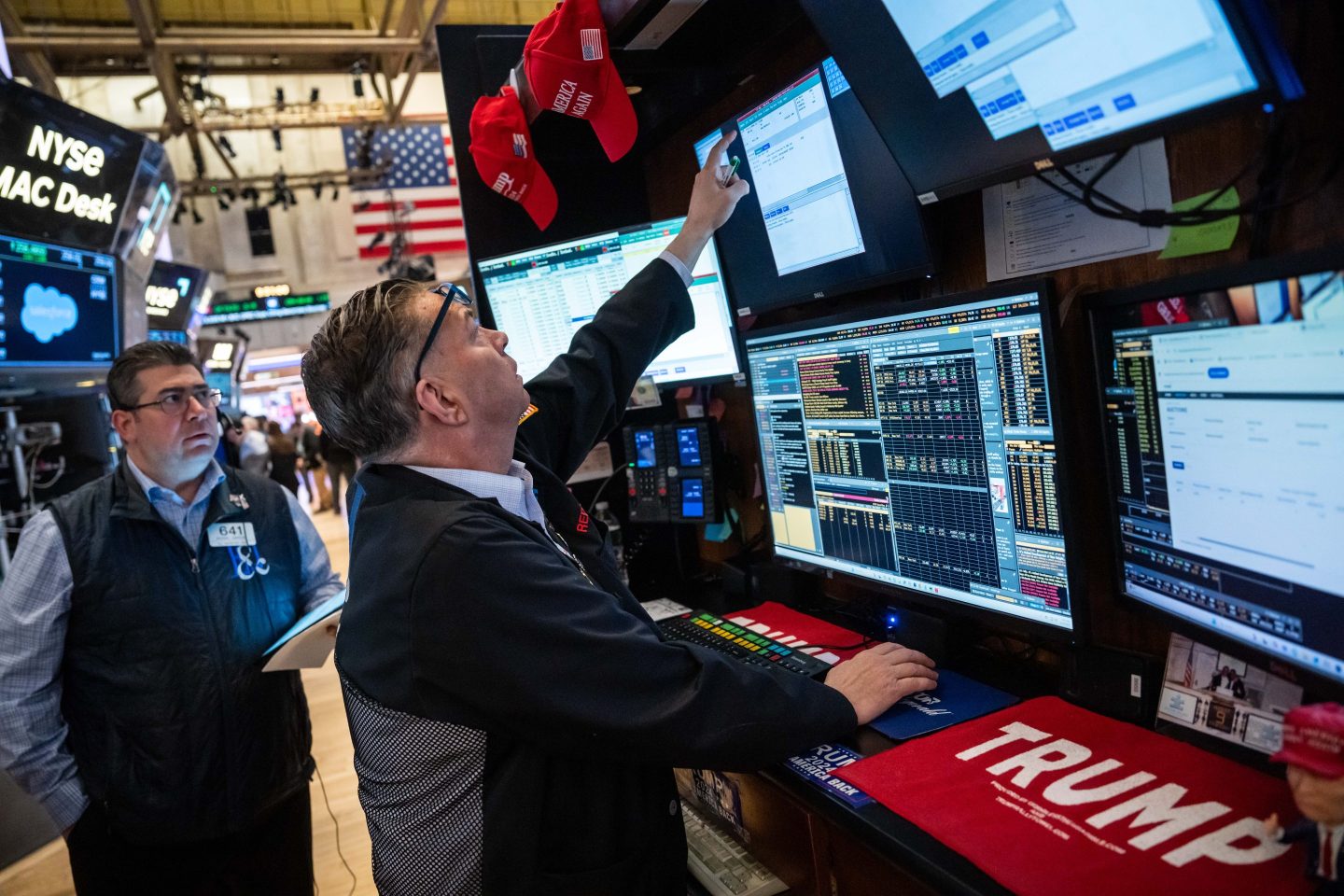 Traders on the floor of the New York Stock Exchange next to Trump memorabilia