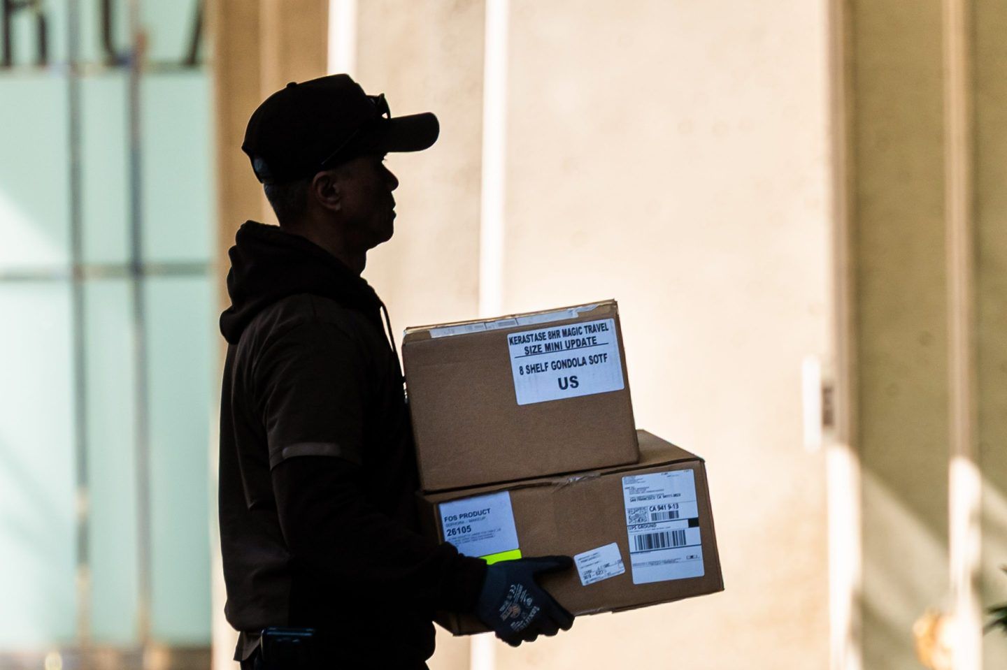 Silhouette of UPS worker holding packages