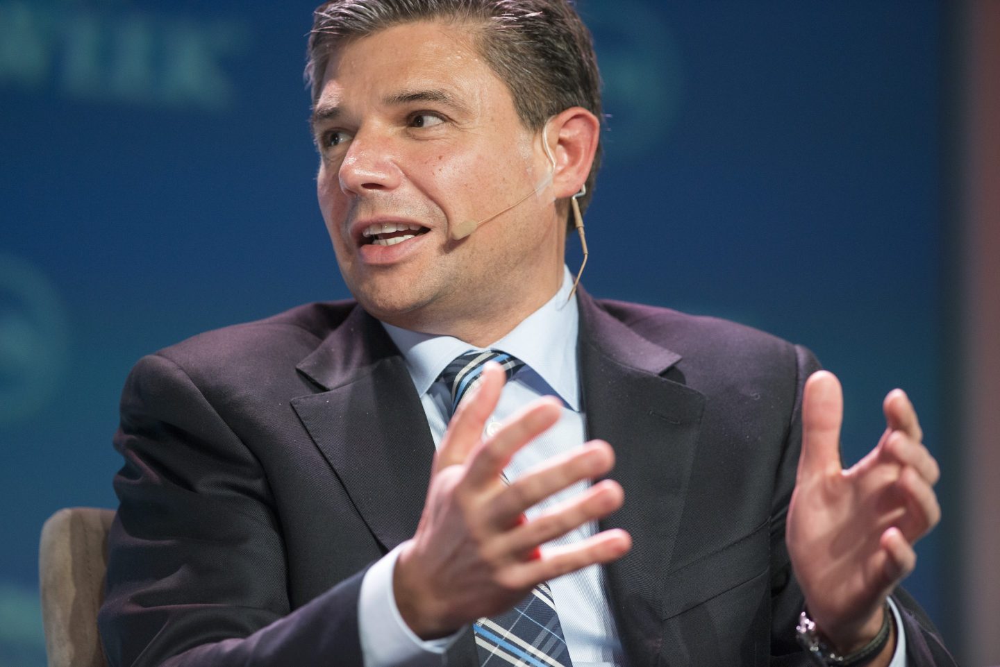 Lorenzo Simonelli speaks while seated during a panel at the CERAWeek conference in Houston.