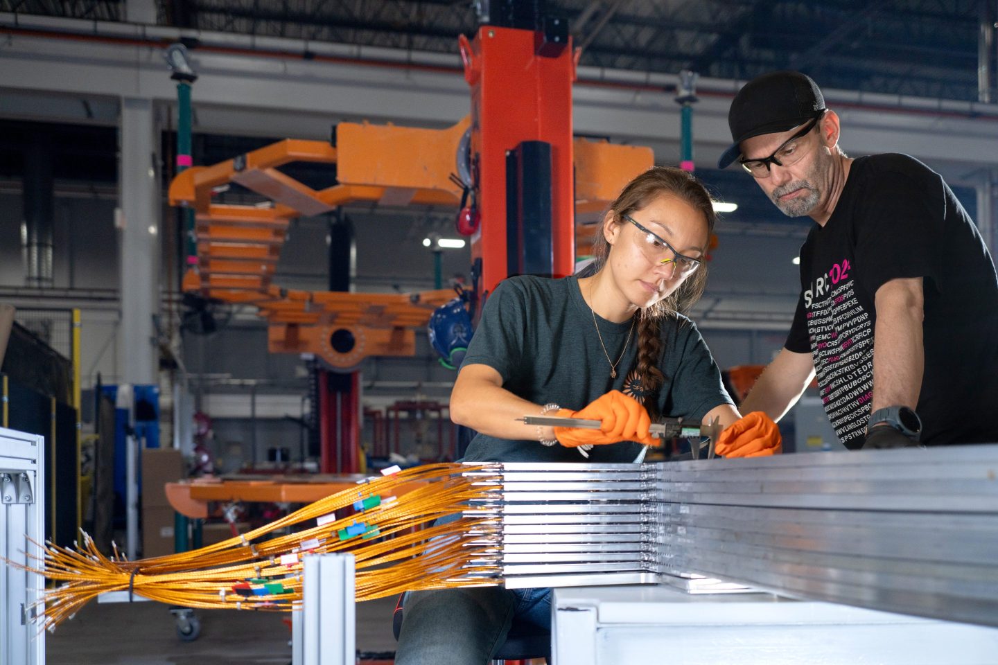 Technicians at Commonwealth Fusion Systems check on a stack of toroidal field magnets.