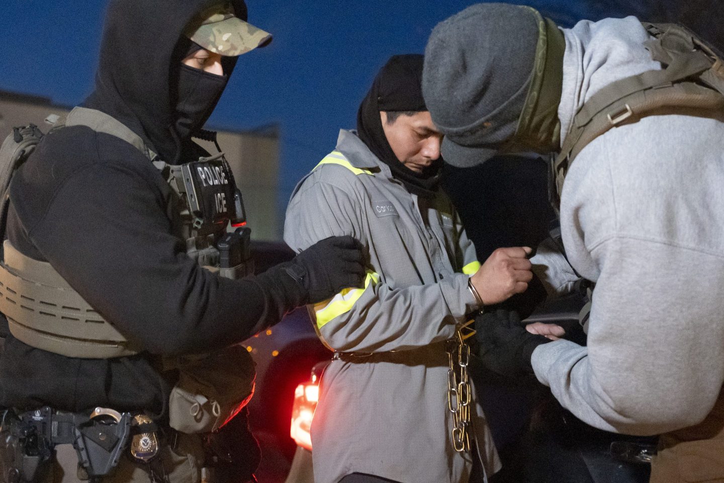 mmigration and Customs Enforcement officers use a chain to more comfortably restrain a detained person using handcuffs positioned in front, Jan. 27, 2025, in Silver Spring, Md. 