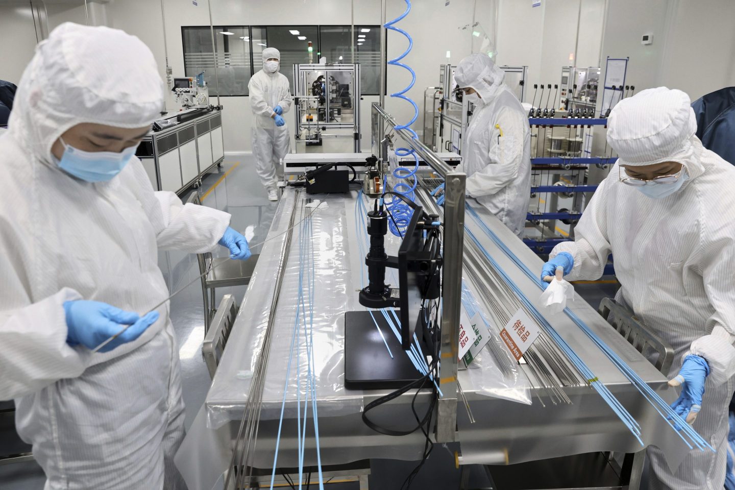 Workers labor at a manufacturer of medical polymer precision catheters, in Nantong city in east China's Jiangsu province on April 24, 2025.