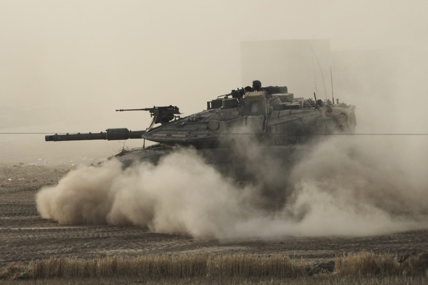 An Israeli tank moves in a staging area in southern Israel, near the border with Gaza, on Friday.