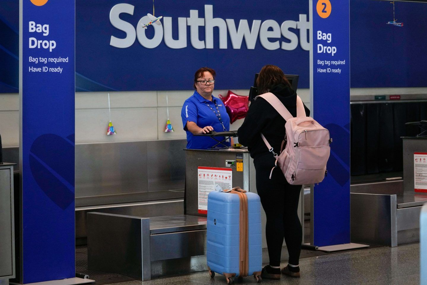 A Southwest Airlines traveler checks a bag at Midway International Airport, on March 11, 2025, in Chicago.