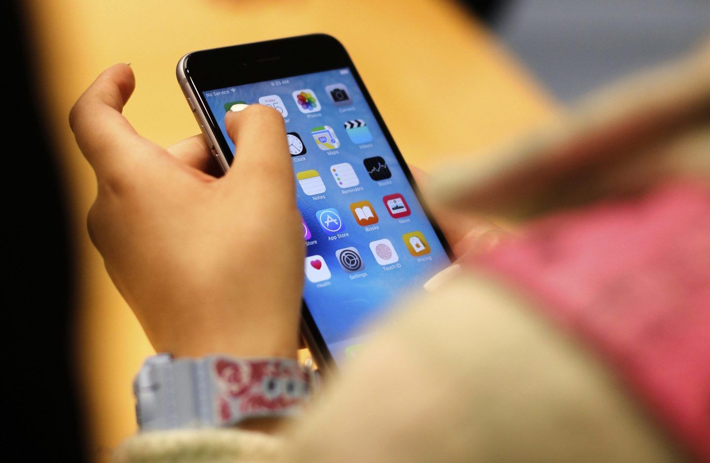 A child holds an iPhone at an Apple store on Sept. 25, 2015 in Chicago.