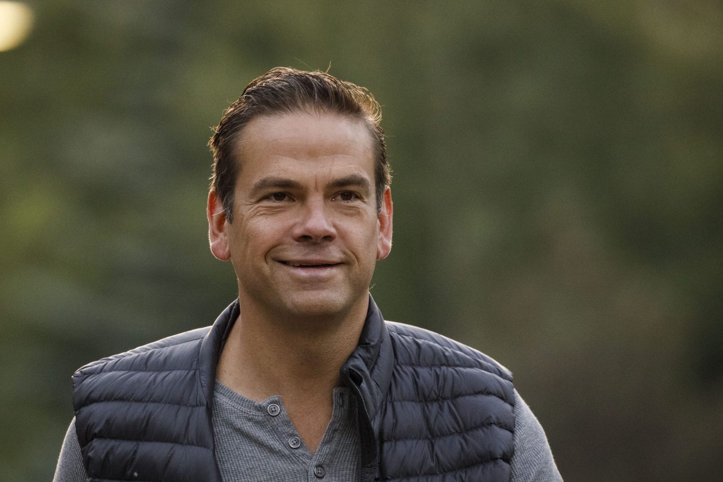 Lachlan Murdoch smiles while wearing that poofy-style vest typically reserved for super rich people