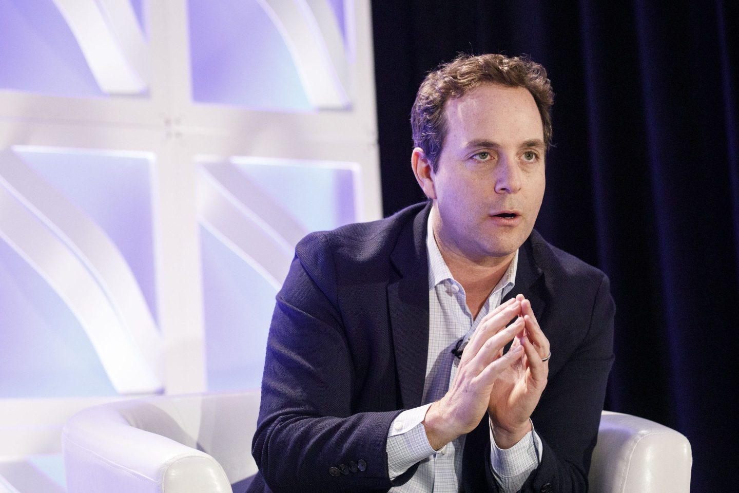 Spencer Rascoff holds his hands together on stage