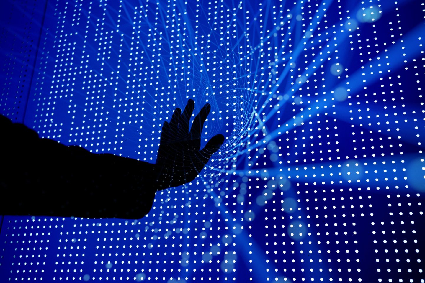 The silhouette of a hand on a background full of data.