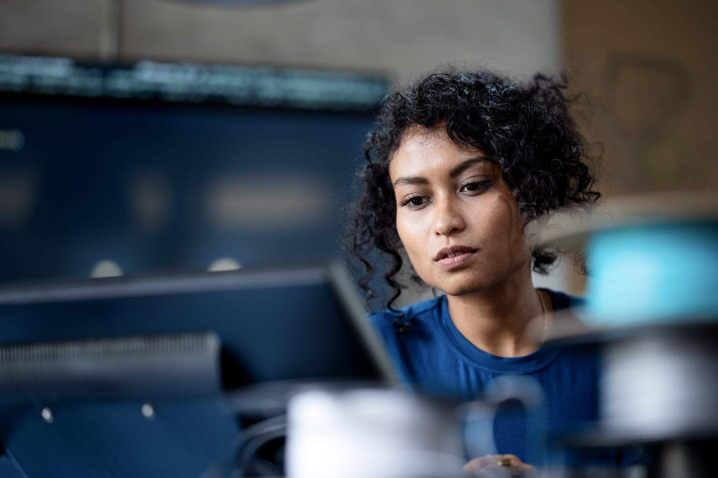 Woman looks at computer screen