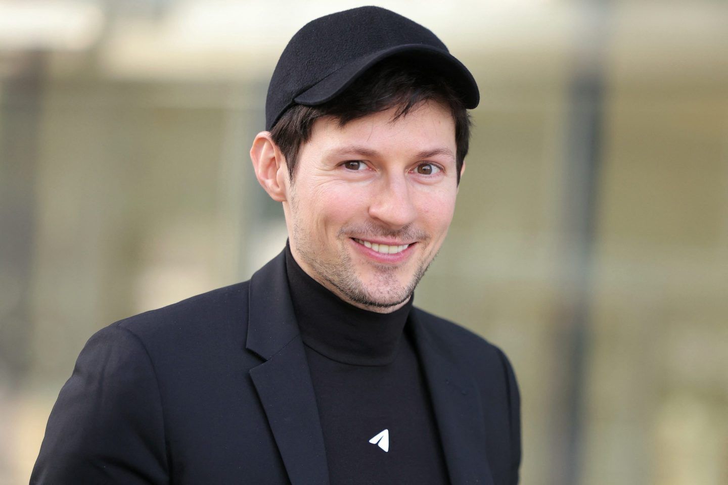 Telegram founder Pavel Durov smiles while wearing an all-black outfit