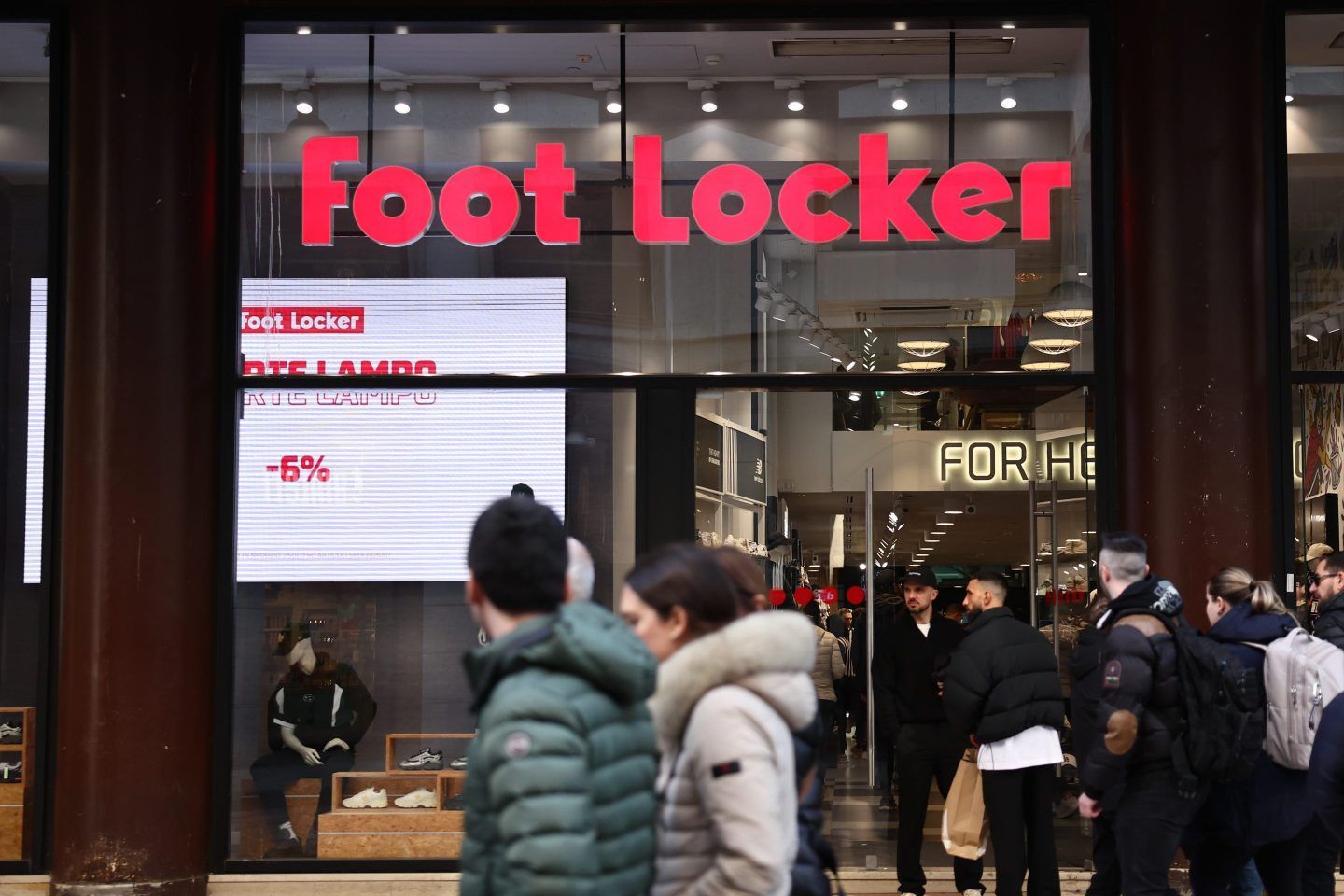 customers walking by Foot Locker store