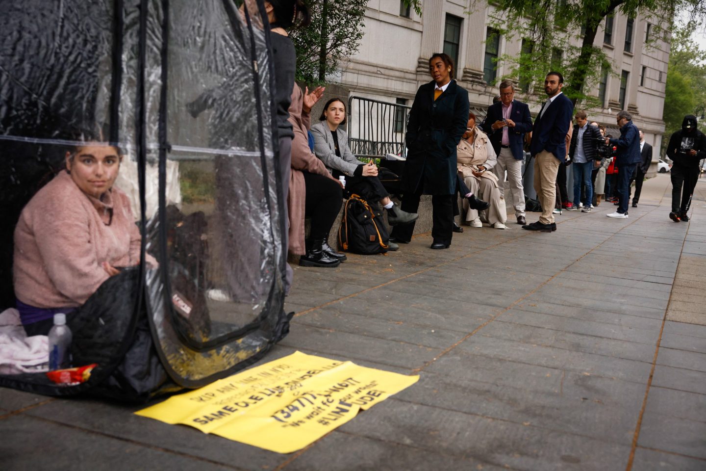 Woman with Same Ole Line Dudes in Diddy trial line.