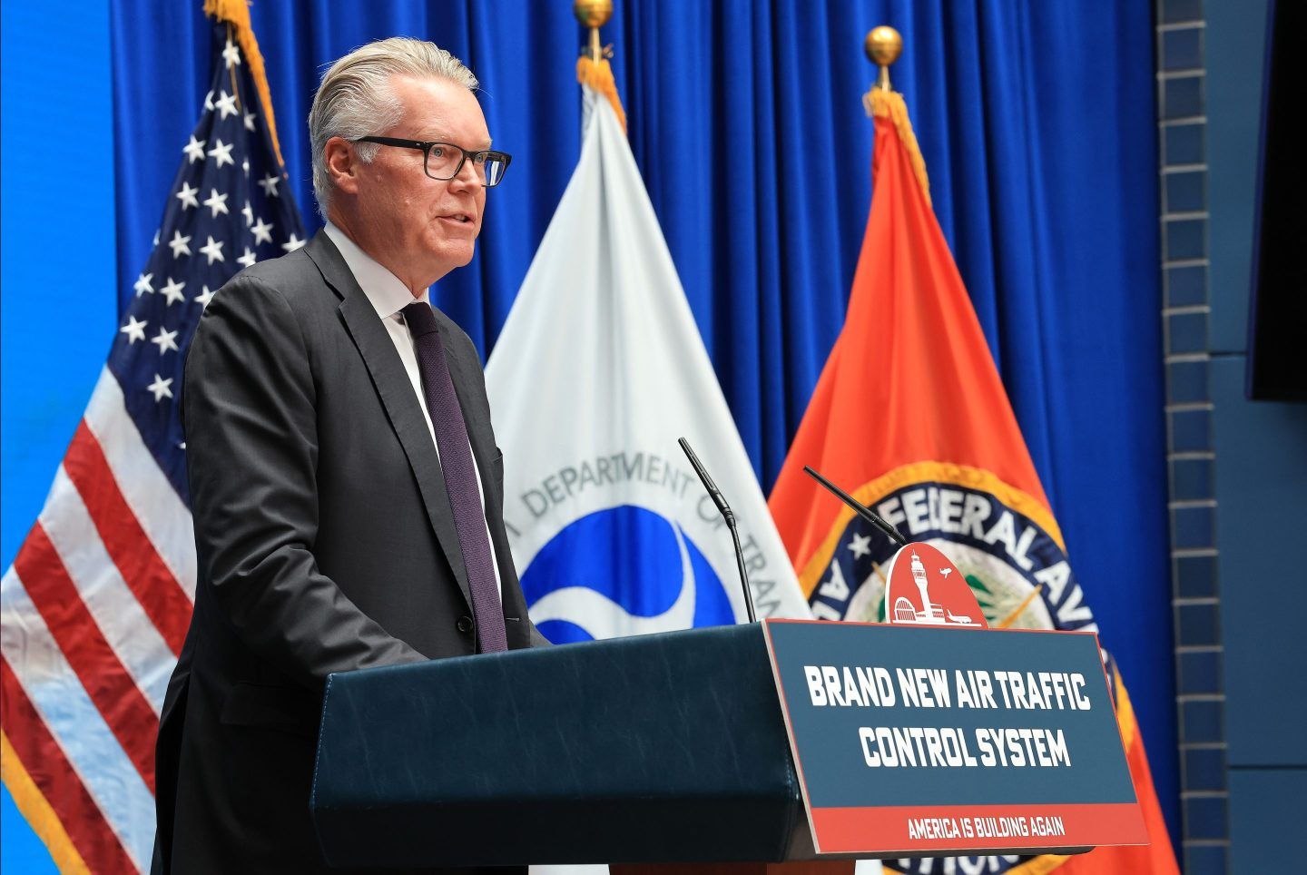 Delta CEO Ed Bastian speaking at a podium