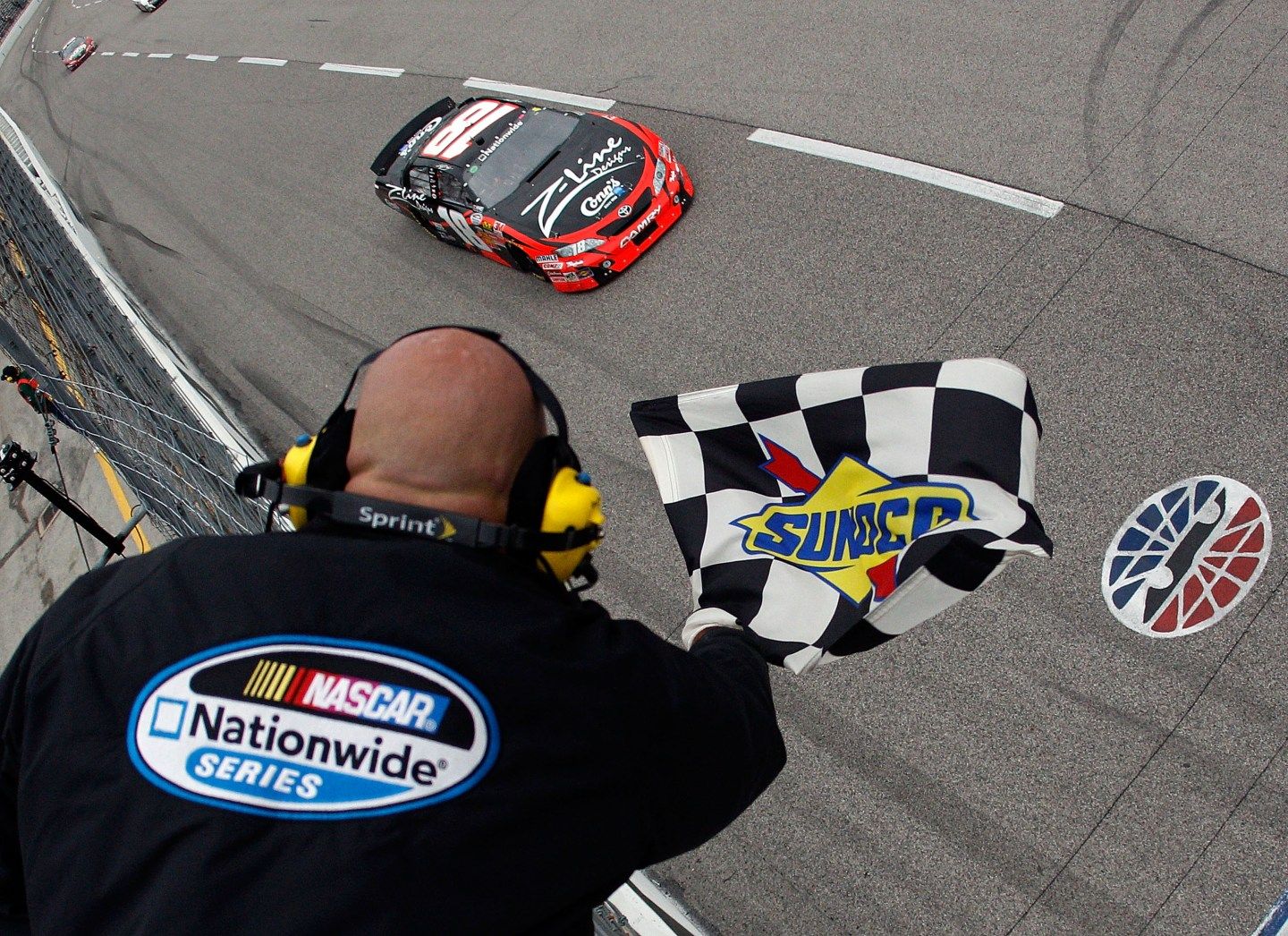 A Sunoco checkered flag is waved at a Nascar race at Texas Motor Speedway.