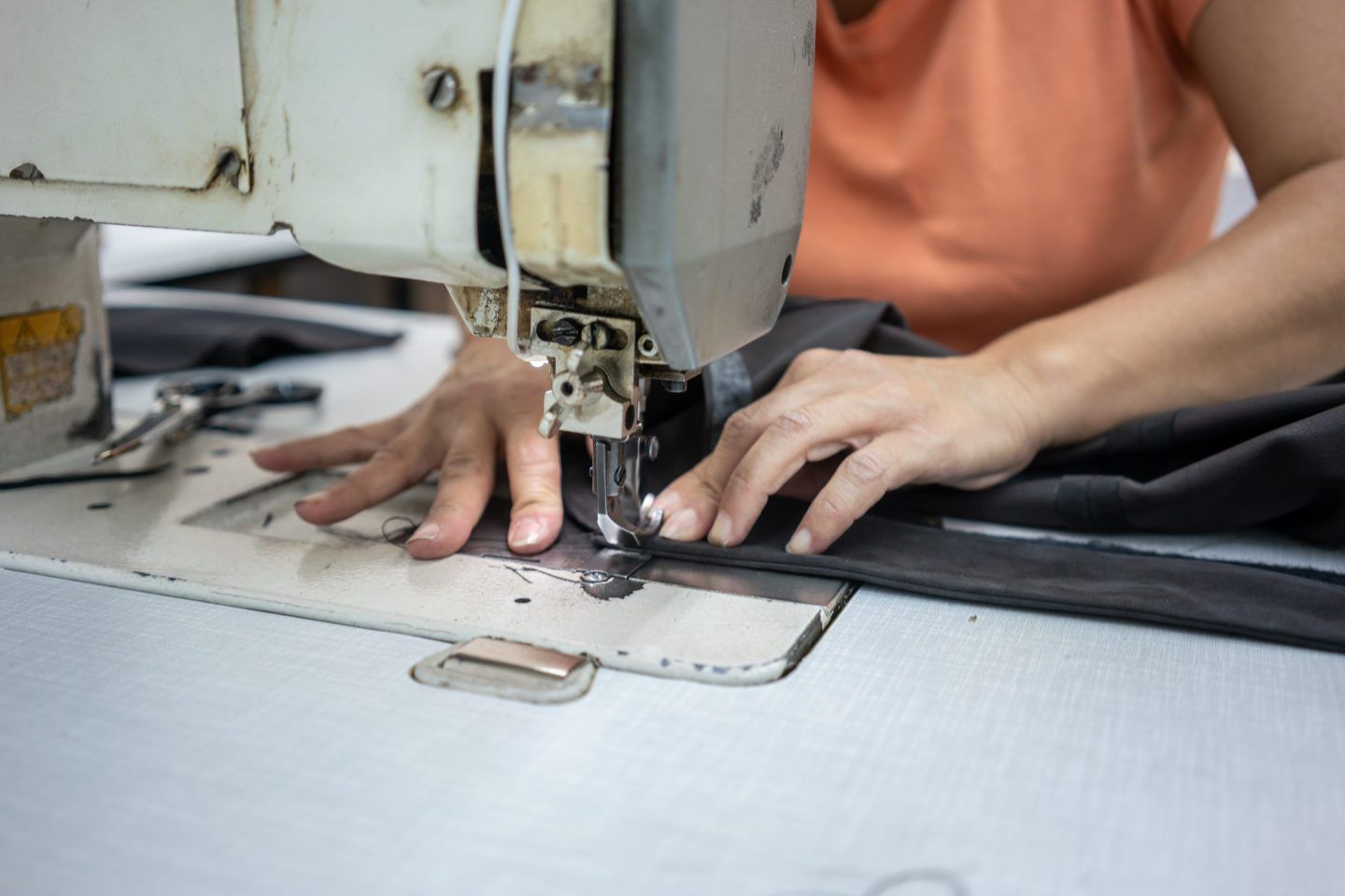 female hands are working with sewing machine