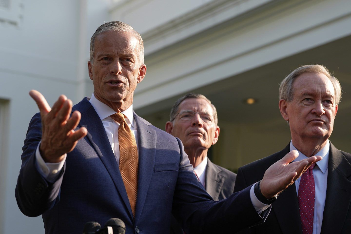 Senate Majority Leader John Thune, flanked by Sen. John Barrasso, speaks with reporters at a lectern after meeting with President Donald Trump at the White House on June 4.