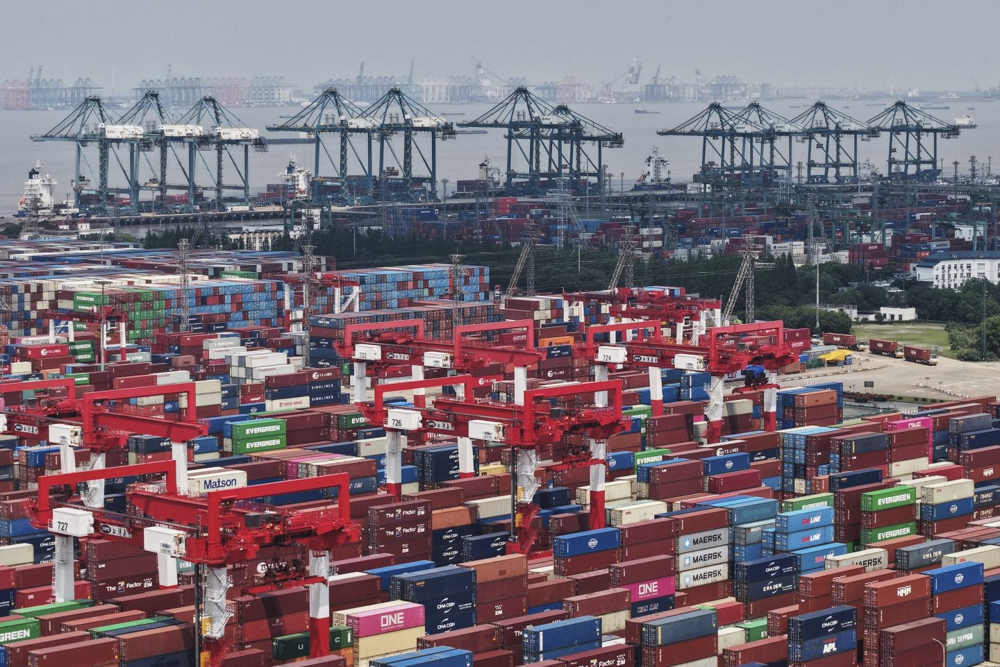Trucks loaded with container move through a container terminal port in Shanghai on June 9, 2025.