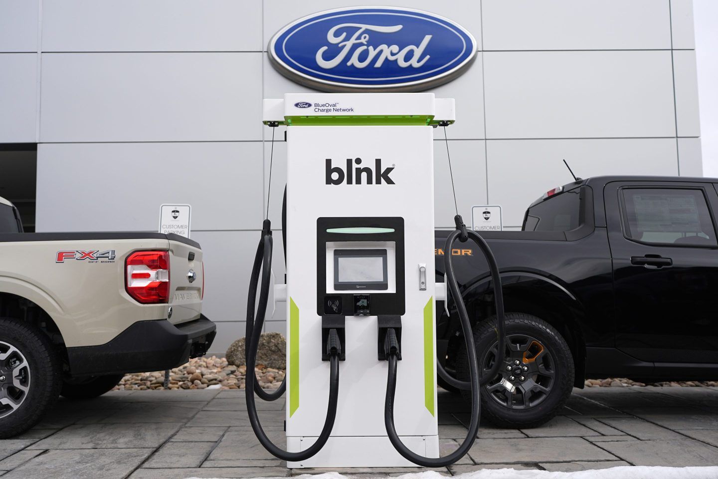 Electric vehicle chargers sit outside a Ford dealership, Jan. 21, 2024, in Broomfield, Colo.