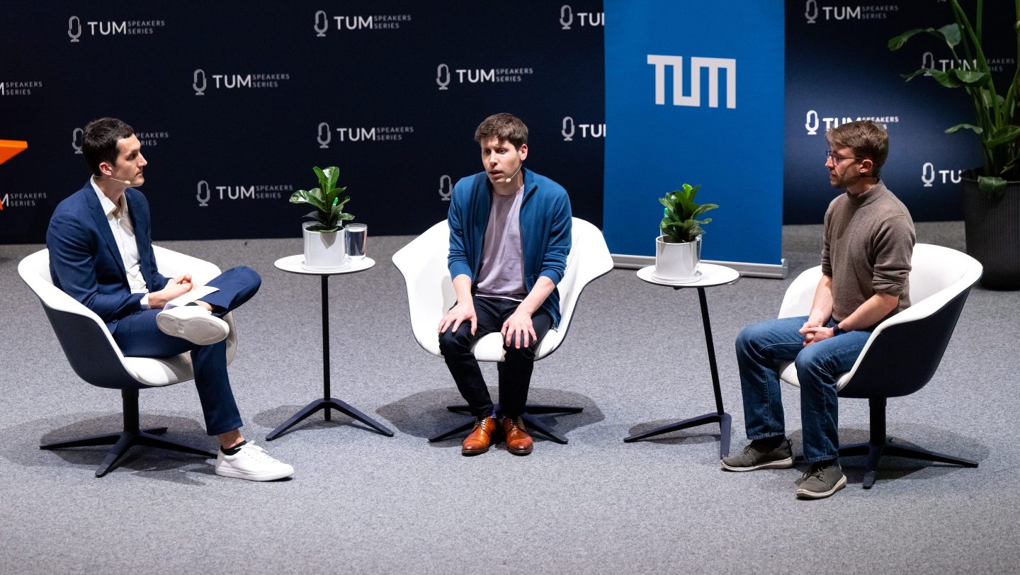 Johannes Heidecke (R), OpenAI's head of safety systems talks with Reinhard Heckel (L), professor of machine learning at the Department of Computer Engineering at TUM, and OpenAI CEO Sam Altman, in a panel discussion at the Technical University of Munich (TUM) in May 2023.