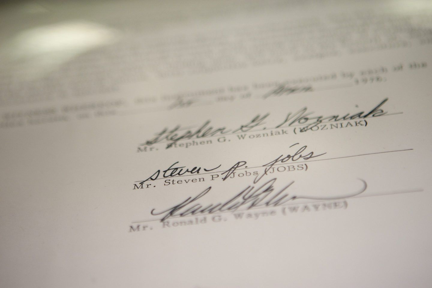 Steve Jobs, Steve Wozniak, and Ronald Wayne's signatures on the bottom of Apple's founding contract.