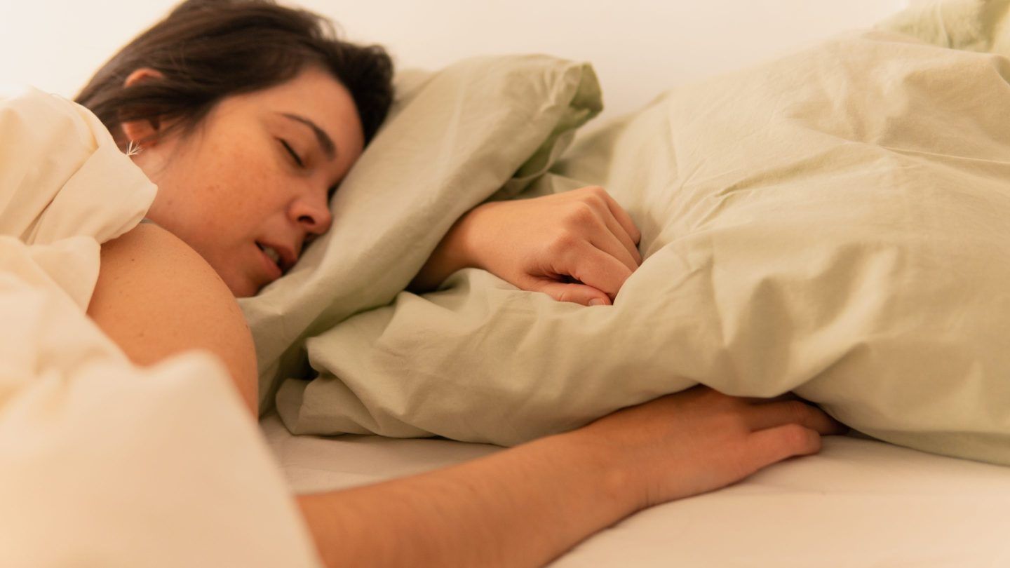 Photo of a woman sleeping with open mouth