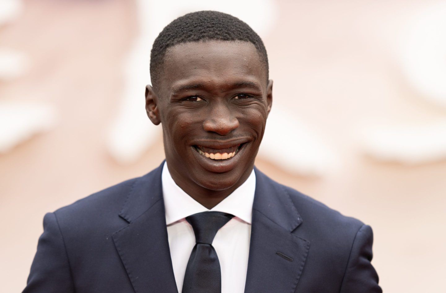 Khaby Lame smiles at a movie premiere