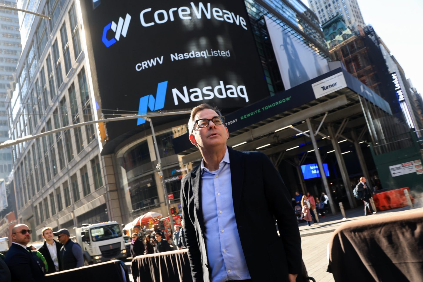 Michael Intrator in front of a NASDAQ billboard in New York City.
