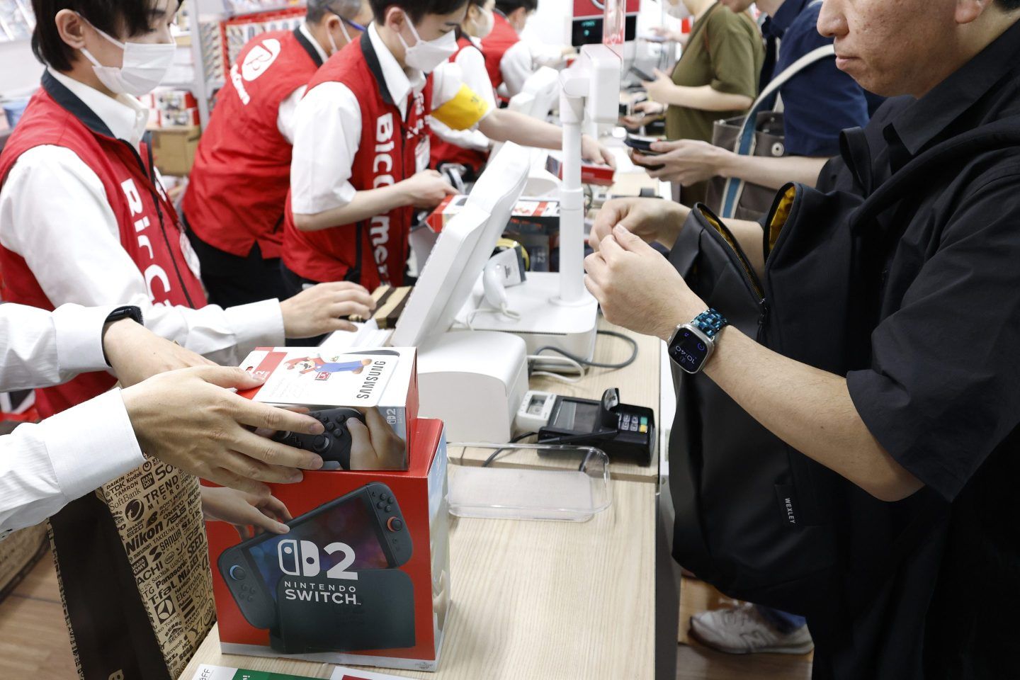 Customers purchase Nintendo's Switch 2 game consoles at a Bic Camera electronics store in Tokyo on June 5, 2025.