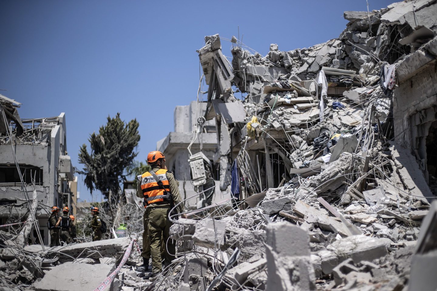 A search and rescue team conducts operations amid the rubble of a destroyed building in Rishon LeZion, Israel, on Saturday.