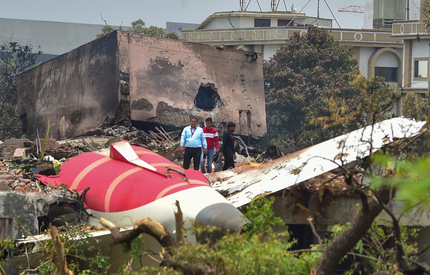 Investigative officials stand at the site of Air India Boeing 787 which crashed on June 13, 2025 in Ahmedabad, India.